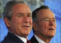  ?? Mandel Ngan/AFP/Getty Images ?? Former President George W. Bush, left and his father George H.W. Bush are shown in 2008 during the dedication of the new U.S. embassy in Beijing.