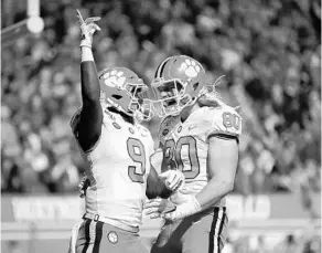  ?? STREETER LECKA/GETTY ?? Clemson’s Travis Etienne, left, celebrates with teammate Luke Price (80) after running for a touchdown earlier this season. The Tigers will face off with Ohio State in the Fiesta Bowl Saturday.