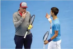  ?? — Reuters ?? Serbia’s Novak Djokovic talks with his coach Boris Becker during a practice session on the eve of his final against Britain’s Andy Murray at the 2016 Australian Open.