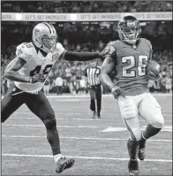  ?? AP/BUTCH DILL ?? Atlanta running back Tevin Coleman (right) runs into the end zone for a touchdown in front of New Orleans safety Vonn Bell (left) in the second half of Monday’s night’s game. Coleman scored three touchdowns to help the Falcons pull away for a 45-32...