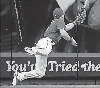  ?? [JOHN MINCHILLO/THE ASSOCIATED PRESS] ?? Reds right fielder Scooter Gennett misses a ball hit by Cubs pitcher Jake Arrieta that went for an RBI triple in the fifth inning.