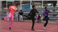  ?? RICHARD DREW — THE ASSOCIATED PRESS ?? In this photo, Tai Sheppard, 11, Rainn Sheppard, 10, and Brooke Sheppard, 8, left to right, do warm-up drills before workouts at Boys and Girls High School, in the Brooklyn borough of New York.