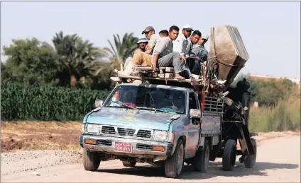  ??  ?? Village workers travel along a road near the village of Tarfa al-Kom in Minya province, Egypt. PICTURE: REUTERS