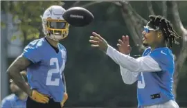  ?? Ringo H.W. Chiu Associated Press ?? DERWIN JAMES JR. throws a ball as safety Nasir Adderley looks on during Chargers training camp. James will not practice without a contract extension.