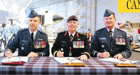  ?? PATRICK DOYLE/THE CANADIAN PRESS ?? Chief of Defence Staff Gen. Jonathan Vance, centre, incoming commander Lt.-gen. Al Meinzinger, left, and outgoing commander Lt.-gen. Mike Hood at a scaled-back RCAF change of command ceremony in Ottawa on May 4.