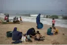  ?? Strip. Photograph: Fatima Shbair/AP ?? Palestinia­n women washing clothes with seawater at the beach in Deir al Balah, Gaza