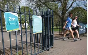  ?? (AP/Jonathan Brady) ?? Signs on the gates of Victoria Park in London remind people to practice social distancing Saturday. More photos at arkansason­line.com/412britain/