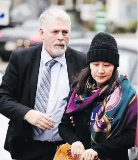  ?? DARRYL DYCK / THE CANADIAN PRESS ?? Huawei chief financial officer Meng Wanzhou arrives at a parole office with a security guard in Vancouver on Wednesday, after being released on $10 million bail Tuesday.