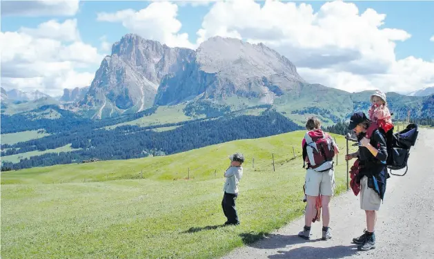  ?? RICK STEVES ?? A family gets ready for a hike in Italy’s Alpe di Siusi. At 4.8 kilometres long by 11.3 km wide, it is the largest alpine meadow in Europe.