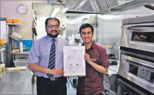  ??  ?? RECIPE FOR SUCCESS: owner Shaukat Chaudhry and his son, Danyal Ali Chaudhry, have added the 2015
Eat Safe Award from Food Standards Scotland and Argyll Bute council to their list of accolades