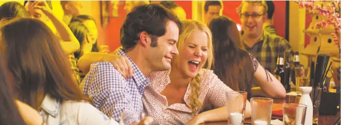  ??  ?? Sake to me: Bill Hader and Amy Schumer in Trainwreck, at Regal Stadium 14, Violet Crown, and DreamCatch­er