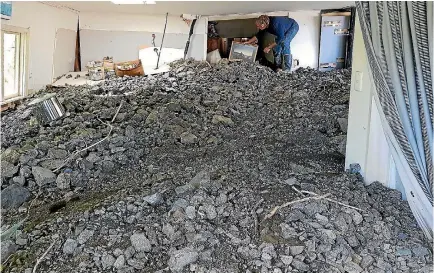  ??  ?? David McIlroy surveys the damage in his home yesterday at Rosy Morn, on State Highway 1 south of Kaikoura, after Gita blew through.