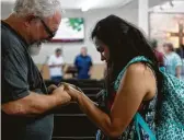  ??  ?? Danielle, Devin Patrick Kelley’s widow, prays with Stephen Willeford, who shot her husband and ended the massacre in Sutherland Springs.