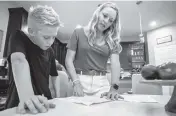  ?? FRAN RUCHALSKI AP ?? Colton Nover, 10, works on a school report with his mother, Holly, in their kitchen in St. Johns, Florida. Both have an issue with stuttering, and University of Delaware speech disorder researcher Ho Ming Chow says, ‘We know stuttering has a really strong genetic component.’