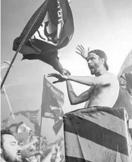  ?? STAFF FILE PHOTO ?? Orlando soccer fans celebrate this season’s opening game for the Lions against D.C. United in March, a match that ended as a 1-1 draw.