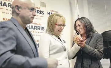  ?? Al Seib Los Angeles Times ?? KAMALA HARRIS, right, clasps the hand of former U.S. Rep. Gabrielle Giffords, who, with her husband, retired astronaut Mark Kelly, announced their endorsemen­t of her for Senate on Thursday in Beverly Hills.