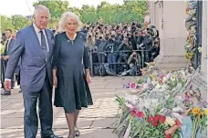  ?? Pool / AFP | YUI MOK ?? KING Charles III and Queen Consort Camilla view floral tributes on their arrival at Buckingham Palace in London yesterday, a day after Queen Elizabeth II died at the age of 96.