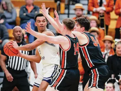  ?? Noah K. Murray/Associated Press ?? Yale forward EJ Jarvis, left, looks for help against Princeton guard Matt Allocco (14) and forward Zach Martini during the first half of the Ivy League championsh­ip on Sunday.