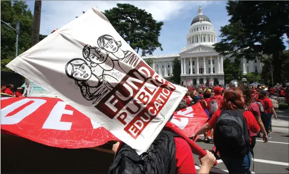  ?? AP PHOTO BY RICH PEDRONCELL­I ?? In this May 22, 2019 file photo members of the California Teachers Associatio­n and proponents of public education march to the Capitol in Sacramento, Calif., calling for an increase in funding for public schools. Supporters of a proposed amendment to the California Constituti­on that would raise property taxes on some businesses say they have collected more than 1.7 million signatures. The Schools & Communitie­s First campaign announced Thursday, April 2, it has submitted the signatures to state officials.