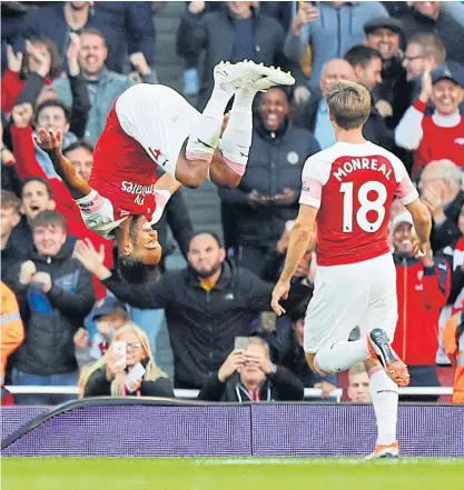  ??  ?? Arsenal’s Pierre-Emerick Aubameyang, left, celebrates after scoring a goal.