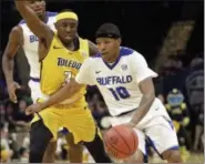  ?? TONY DEJAK — THE ASSOCIATED PRESS ?? Buffalo’s Wes Clark drives past Toledo’s Marreon Jackson during the second half of the Mid-American Conference tournament championsh­ip game on March 10 at Quicken Loans Arena.