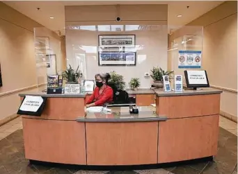  ?? Jerry Lara / Staff photograph­er ?? Frances Velasquez works the reception desk at Bexar Appraisal District. The district was voted the best midsize employer in the San Antonio area.