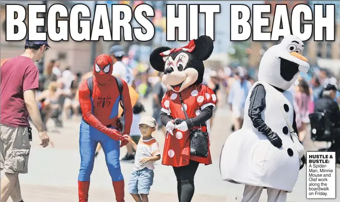  ??  ?? HUSTLE & BUSTLE: A SpiderMan, Minnie Mouse and Olaf work along the boardwalk on Friday.