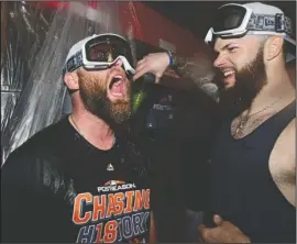  ?? The Associated Press ?? OCTOBER ORBIT: Houston starting pitcher Dallas Keuchel, right, celebrates with Brian McCann Monday after the Astros defeated the Cleveland Indians, 11-3, to sweep their American League Division Series in Cleveland.