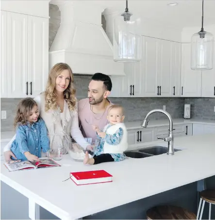  ?? CHRISTINA RYAN ?? Viktoria Titov Kullar and Akash Kullar, with their children Mila, left, and Jiya, settle into their new home at Rise at West Grove Estates.