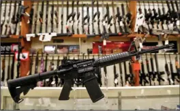  ?? The Associated Press ?? SPORT RIFLE: A Smith & Wesson M&P 15 Sport rifle, the company’s version of the AR-15, sits in a store in New Castle, Pa.