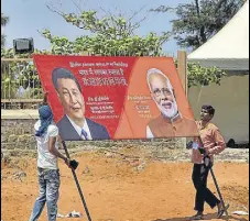 ?? PTI ?? Workers carry a hoarding as preparatio­ns are underway for the summit between PM Modi and Chinese President Xi Jinping in the seaside temple town of Mamallapur­am, on Wednesday.