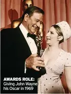  ?? ?? AWARDS ROLE: Giving John Wayne his Oscar in 1969
