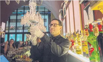  ??  ?? Glasses at the Baccarat Hotel in New York. Hotel employees, though often overlooked, help maintain the patina of opulence in New York hotels. Kenrick Morante, a glass attendant at the Baccarat Hotel in New York. Right