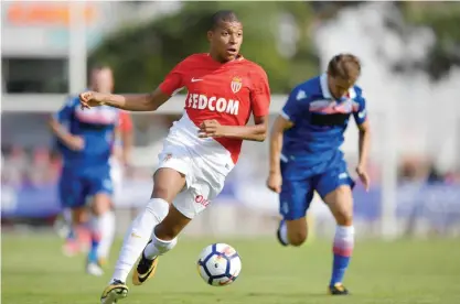  ?? — AFP ?? MARTIGNY: This file photo taken on July 15, 2017 shows Monaco’s forward Kylian Mbappe controling the balll during a friendly football match between AS Monaco and Stoke City FC in Martigny. Real Madrid have reportedly reached a world record deal in...