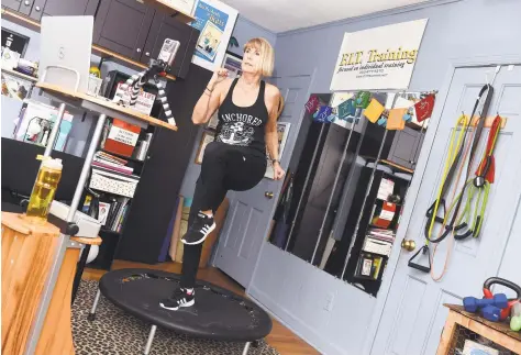  ?? Arnold Gold / Hearst Connecticu­t Media ?? Fitness coach Linda Gottlieb exercises in her Milford home studio where she conducts business online during the stay-at-home period.