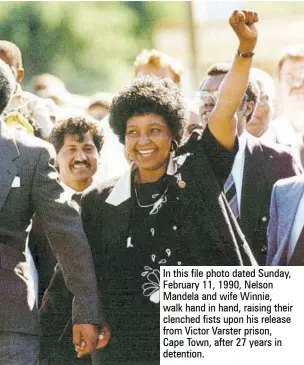  ??  ?? In this file photo dated Sunday, February 11, 1990, Nelson Mandela and wife Winnie, walk hand in hand, raising their clenched fists upon his release from Victor Varster prison, Cape Town, after 27 years in detention.