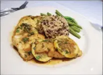  ?? JANET PODOLAK — THE NEWS-HERALD ?? Chicken piccata is one of two entrees diners can choose for a $35-per-couple weeknight special that includes a bottle of wine and a peach dessert.