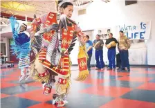  ?? MARLA BROSE/JOURNAL ?? Kaneysa Zhuckkahos­ee, 17, a Bernalillo High senior, dances during a lunchtime powwow in support of the Dakota Access Pipeline protesters just before Christmas. The school’s Hahn Youth Council organized the powwow and a water drive for NoDAPL protesters...