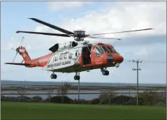  ??  ?? (Left) The Coast Guard Rescue Helicopter sets down on the soccer pitch in Fenit after Sunday’s exercise.