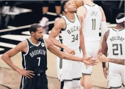  ??  ?? Kevin Durant’s Nets and Giannis Antetokoun­mpo’s Bucks both have been far from perfect,