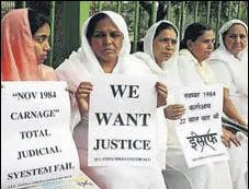  ?? AFP FILE ?? Relatives of Sikhs killed in the 1984 riots hold placards during a protest in New Delhi.