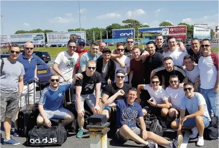  ??  ?? Team bonding EKYM players and coaches at Prestwick Airport before their trip to Benidorm