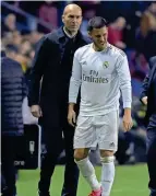  ?? AFP ?? OUCH: Real Madrid’s Eden Hazard grimaces in pain as team coach Zidane looks on. —