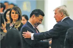  ?? THOMAS PETER/POOL PHOTO VIA AP ?? China’s President Xi Jinping, center, U.S. President Donald Trump and first lady Melania Trump attend a state dinner Thursday at the Great Hall of the People in Beijing. ‘You’re a very special man,’ Trump told Xi in an appearance earlier Thursday...