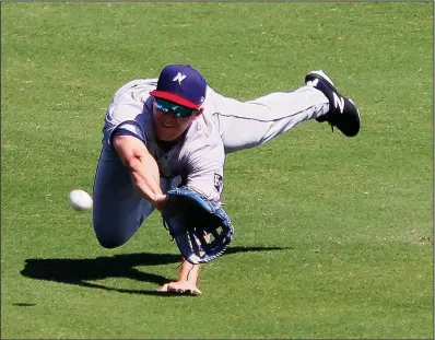  ?? Arkansas Democrat-Gazette/THOMAS METTHE ?? Northwest Arkansas center fielder Donnie Dewees makes a diving catch during the bottom of the fourth inning of the Naturals’ 3-2 loss to the Arkansas Travelers on Sunday at Dickey-Stephens Park in North Little Rock. Dewees went 3 for 5 in the loss.