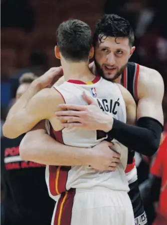  ??  ?? The Portland Trail Blazers’ Jusuf Nurkic, right, giving the Miami Heat’s Goran Dragic a hug after a game this month, began this season with the Nuggets. Lynne Sladky, The Associated Press