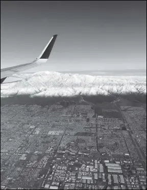  ?? Associated Press ?? Snow covers Mount Baldy in the San Gabriel Mountains on Friday. A winter storm brought a deluge of rain and snow to Southern California, shutting down Interstate 5 in Tejon Pass through the mountains and dozens of miles of Interstate 15 from Baker to Primm, Nevada.