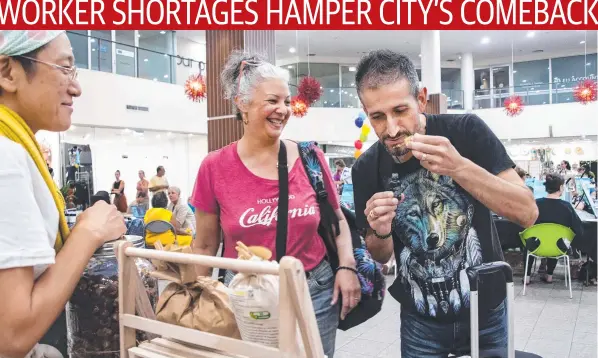  ?? ?? Melbourne couple Harlene Hercules (centre) and Rob Patiriadis (right) spent the last hours of their Cairns holiday shopping at the Health, Happiness and Harmony Expo at The Pier, sampling Inner Nature wares watched by business owner Masayo Ueda (left). Picture: Brian Cassey