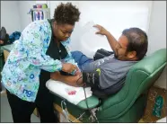  ?? RECORDER PHOTO BY CHIEKO HARA ?? Phlebotomi­st Jasmyne Johnson, left, checks the veins of Armando Ortega, first time donor, Wednesday, Sept. 26, 2018 at the blood drive at Black Bear Diner parking lot in Portervill­e.