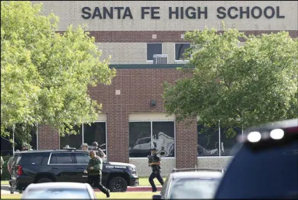  ?? HOUSTON CHRONICLE VIA AP ?? Law enforcemen­t officers respond to Santa Fe High School after an active shooter was reported on campus Friday.
